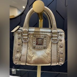 Runway Versace Runway Medusa Bag.  
Light gold Leather Has a cross body strap